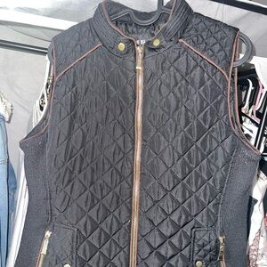 Black quilted vest with gold zipper detailing